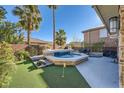 A serene backyard showcases a stone-accented pool with waterfall features and palm trees at 5442 Bristol Bend Ct, Las Vegas, NV 89135