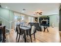 Bright living room with wood floors, connecting the dining area, with views of the pool outside at 5442 Bristol Bend Ct, Las Vegas, NV 89135