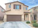 Two-story home with a two-car garage and desert landscaping at 5513 Silent Springs Dr, Las Vegas, NV 89122