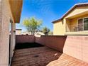 This backyard has a wooden deck and a patch of green grass for outdoor enjoyment at 5634 Bishop Flowers St, Las Vegas, NV 89130