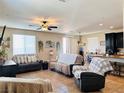 Well-lit open living room featuring tile floors and large windows with decorative accents at 5634 Bishop Flowers St, Las Vegas, NV 89130