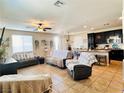 Spacious living room featuring tile floors and an open floor plan with an eat-in kitchen at 5634 Bishop Flowers St, Las Vegas, NV 89130
