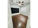 Cozy bedroom with laminate flooring, ceiling fan, and a window for natural light at 5711 Roundrock Dr, Las Vegas, NV 89142