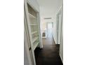 Bright upstairs hallway featuring wood floors, white trim and ample closet space at 5711 Roundrock Dr, Las Vegas, NV 89142
