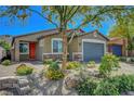 Attractive single-Gathering home with a vibrant front garden and a two-car garage at 5957 Olivine Falls Ave, Las Vegas, NV 89130