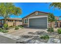 Lovely front exterior showcasing a spacious driveway and well-maintained landscaping at 5957 Olivine Falls Ave, Las Vegas, NV 89130