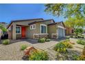 Inviting single-story home with a colorful front door and xeriscaped front yard at 5957 Olivine Falls Ave, Las Vegas, NV 89130