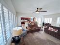 Bright and airy living room with plush sofas and ample natural light from shuttered windows at 6134 Burleson Ranch Rd, Las Vegas, NV 89131
