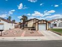 Charming single-story home showcasing a one-car garage and unique desert landscaping at 7268 Wichita Ct, Las Vegas, NV 89119