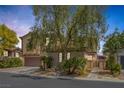 Attractive two-story home boasts well-maintained landscaping, creating a welcoming curb appeal at 7872 Regency Park St, Las Vegas, NV 89149