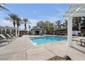 Resort-style community pool with lounge chairs, cabanas, and lush landscaping for relaxation and enjoyment at 805 Dana Hills Ct # 104, Las Vegas, NV 89134