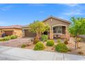 Charming single-story home featuring a well-manicured yard, a two-car garage and stone accents at 8058 Big Skye Ranch St, Las Vegas, NV 89166