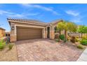 Charming single-story home with desert landscaping, a paved driveway, and stone facade accents at 8058 Big Skye Ranch St, Las Vegas, NV 89166