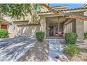 Inviting front porch with gated entrance and covered seating area leading to the front door at 8091 Mosaic Sunrise Ln, Las Vegas, NV 89166