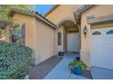 Welcoming entryway with a covered porch and decorative potted plants leading to the front door at 8840 Arroyo Azul St, Las Vegas, NV 89131