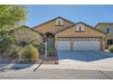 Inviting single-story home with a well-manicured front yard and a two-car garage at 8840 Arroyo Azul St, Las Vegas, NV 89131