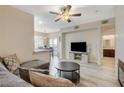 Inviting living room features modern ceiling fan, plank floors, and seamless flow into the dining area at 9050 W Warm Springs Rd # 1074, Las Vegas, NV 89148