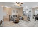 A cozy living room featuring an open layout leading to a modern kitchen with stainless steel appliances at 9050 W Warm Springs Rd # 1074, Las Vegas, NV 89148