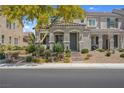 Charming townhome featuring beautiful desert landscaping, a well-manicured lawn, and a shade tree at 946 Belton Lake Ave, North Las Vegas, NV 89086