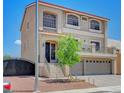 Charming two-story home boasts elegant architectural details, a well-maintained yard, and an attached two-car garage at 9656 Paraiso Springs St, Las Vegas, NV 89139