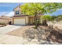 Charming two-story home showcasing a well-manicured rock garden at 977 Trackers Glen Ave, Henderson, NV 89015