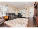 Inviting living room with hardwood floors, neutral paint, and large windows at 977 Trackers Glen Ave, Henderson, NV 89015