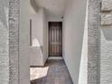 Inviting entryway with a covered porch and a stylish dark brown front door, perfect for a warm welcome at 1063 Upper Springs St, Henderson, NV 89002