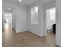 Bright hallway with tile flooring, built-in alcove and access to a bathroom and multiple rooms at 1063 Upper Springs St, Henderson, NV 89002
