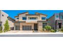 Contemporary two-story home showcasing a clean design with large windows and a three-car garage at 10748 Steel Ridge Ct, Las Vegas, NV 89135