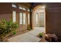 Inviting front entrance with desert landscaping and well-lit arched doorway at 12 Kennesaw Rd, Henderson, NV 89052