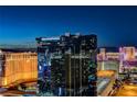 Night view of Hilton Grand Vacations building and skyline reflecting on the windows at 145 E Harmon Ave # 3807, Las Vegas, NV 89109