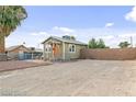 Charming single story home with a large parking area and a chain link fence at 1718 Marlin Ave, Las Vegas, NV 89101