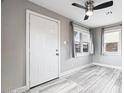 Bright living room featuring hard surface floors, two windows, and a modern ceiling fan at 1718 Marlin Ave, Las Vegas, NV 89101