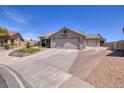 Long driveway leading to a charming single-story home with desert landscaping and a two-car garage at 190 Channel Dr, Henderson, NV 89002