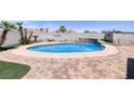Inviting in-ground pool surrounded by decorative paving and a lushly landscaped backyard at 190 Channel Dr, Henderson, NV 89002