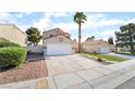 Charming single-Gathering home boasts a two-car garage and a well-manicured front yard in a suburban neighborhood at 2046 Waverly Cir, Henderson, NV 89014
