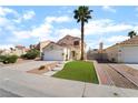 Charming single-Gathering home boasts a two-car garage and a well-manicured front yard in a suburban neighborhood at 2046 Waverly Cir, Henderson, NV 89014