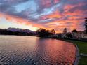 Scenic view of the lake at sunset with orange and pink clouds reflecting in the water at 2529 Seascape Dr, Las Vegas, NV 89128
