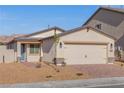 Single-story home featuring a two-car garage, neutral stucco, and low maintenance landscaping at 2611 Freya Valley St, Las Vegas, NV 89156