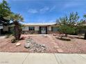 Inviting single-story home with desert-style landscaping and a decorative rock pathway at 3144 Downing Pl, Las Vegas, NV 89121