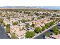 An aerial view showcasing a neighborhood with homes and scenic mountain views in the distance at 3367 Popcorn Flower St, Las Vegas, NV 89117