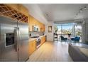 Open concept with stainless steel appliances, wood cabinets, and a view of the dining area and living room at 353 E Bonneville Ave # 215, Las Vegas, NV 89101