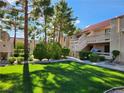 Condo complex featuring manicured lawns and mature trees and desert landscaping at 3750 Desert Marina Dr # 37, Laughlin, NV 89029