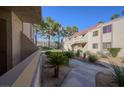 Manicured exterior of condo complex with mature trees and desert landscaping at 3791 Desert Marina Dr # 109, Laughlin, NV 89029