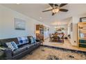Cozy living room with a decorative rug and ample seating that connects to a dining area with natural light at 4075 W Torino Ave, Las Vegas, NV 89139