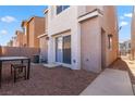 Private backyard area with low-maintenance gravel, perfect for outdoor dining or relaxing, featuring a small table set at 4076 Rocky Beach Dr, Las Vegas, NV 89115
