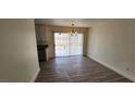 Bright dining area with wood-look tile flooring and sliding glass doors to the backyard at 4308 Apex Dr, Las Vegas, NV 89147