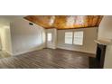 Bright living room with wood-look tile flooring, vaulted wood ceiling and a black fireplace at 4308 Apex Dr, Las Vegas, NV 89147