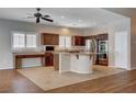 Open kitchen features granite countertops, stainless steel appliances, and a large center island with a gas cooktop at 4334 Libbiano Ct, Las Vegas, NV 89141