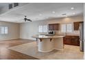 Spacious kitchen featuring a center island cooktop, stainless refrigerator, and plenty of cabinet storage at 4334 Libbiano Ct, Las Vegas, NV 89141